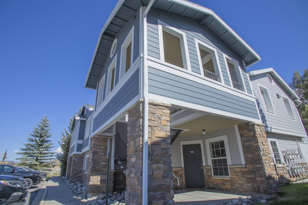 a view of the front of a house with a blue sky background