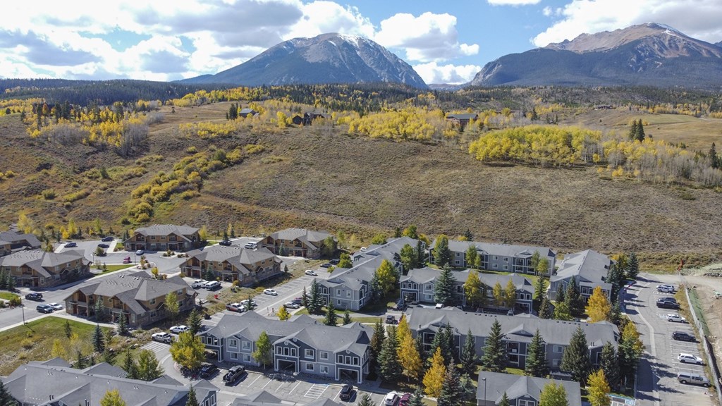 an aerial view of a community with mountains in the background