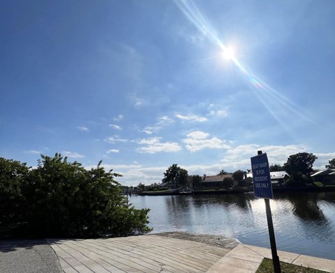 A sign on a post by the water reads "No swimming allowed.".