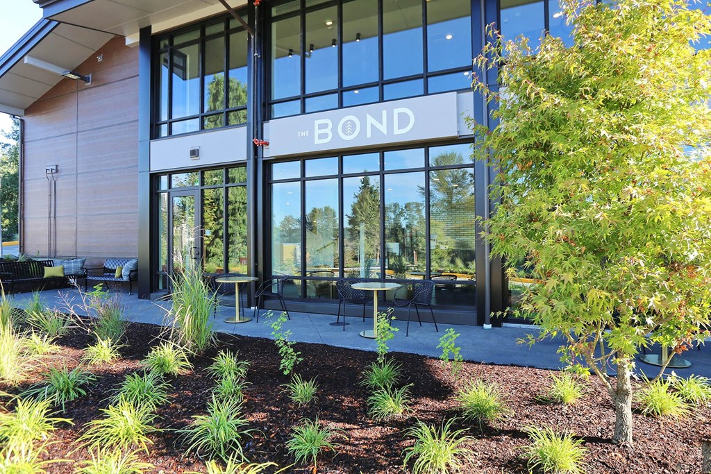 a building with large glass windows and a sign that says bond