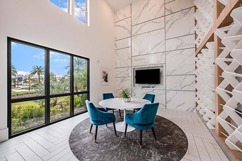 A modern dining room with a round table and chairs.