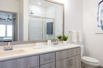 A bathroom with a white sink and a mirror above it.