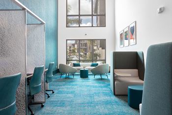 A room with blue carpet and white furniture.
