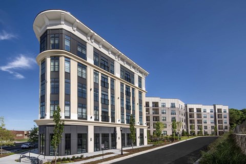 A modern building with a curved corner and large windows.