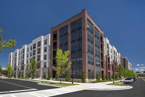 A modern multi-story building with a mix of brick and glass facade.