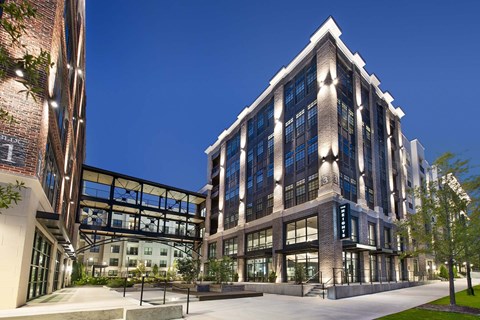 A modern building with a glass facade and a brick exterior.