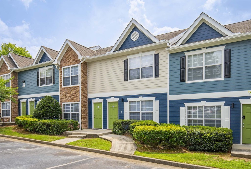 A row of houses with blue and beige siding.