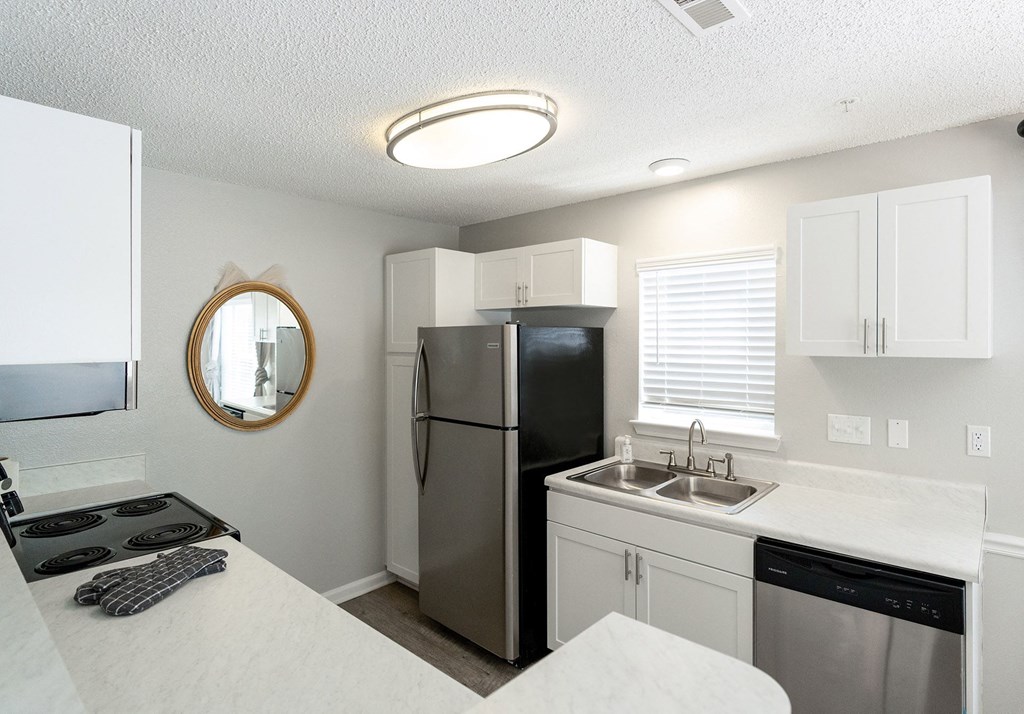 the preserve at ballantyne commons apartment kitchen with stainless steel appliances and white cabinets