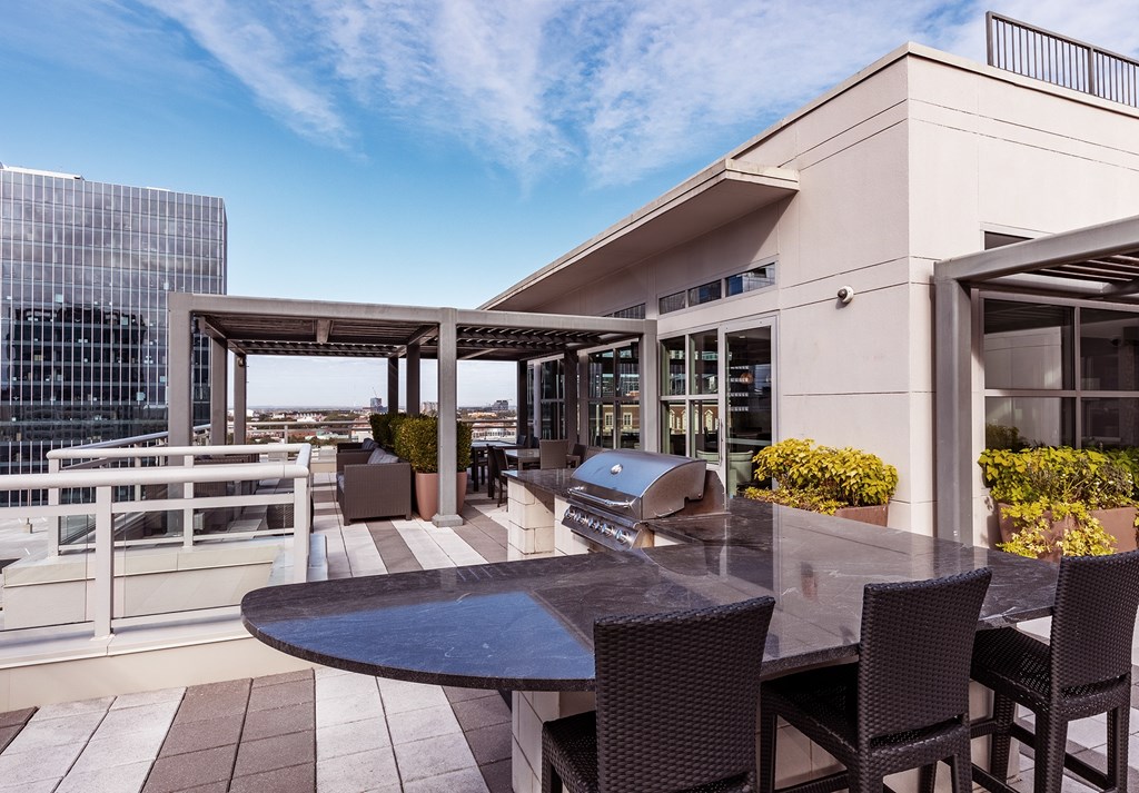 A table with chairs is on a balcony.