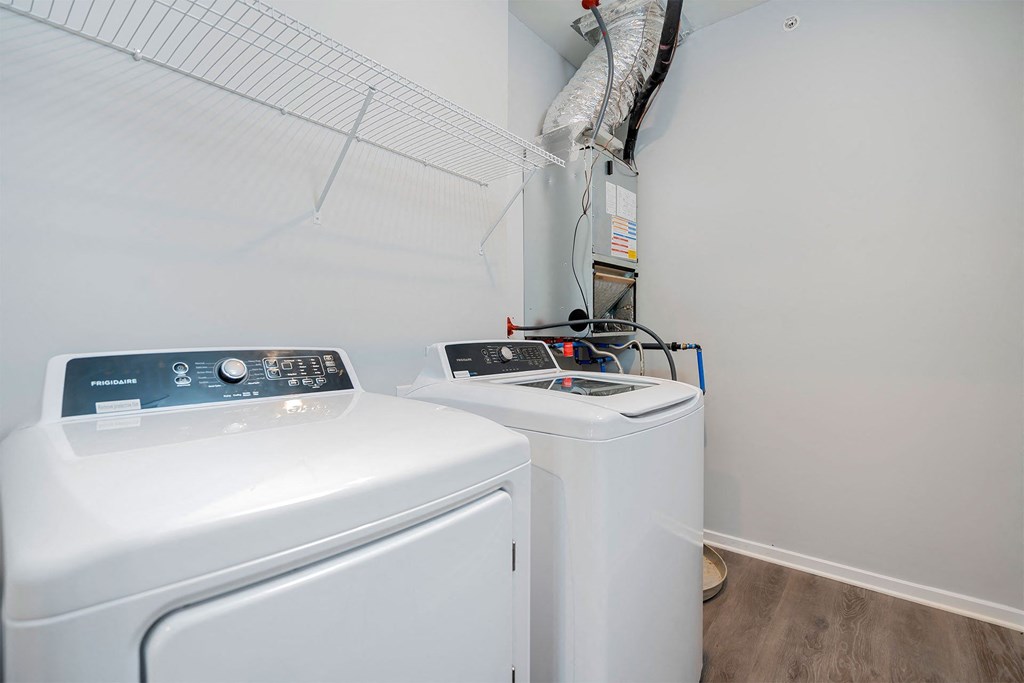 A white washing machine and dryer in a small laundry room.