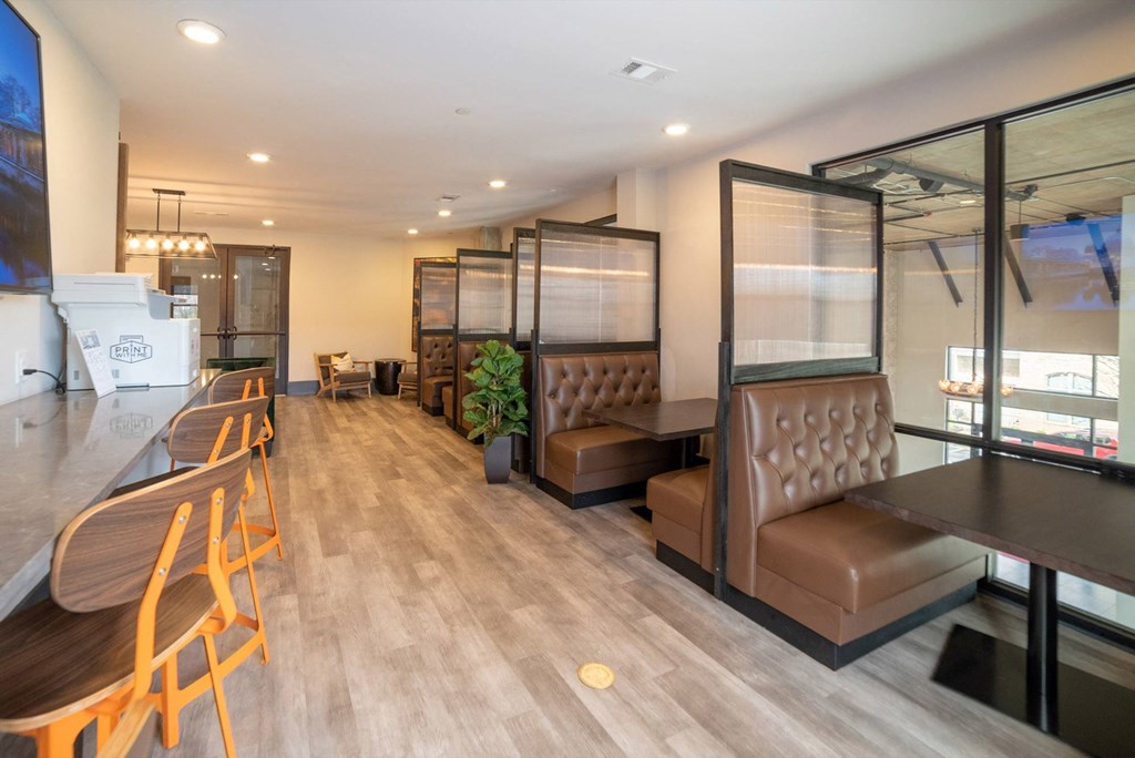 a seating area in a restaurant with chairs and tables