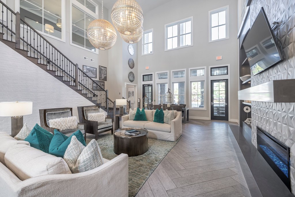 A living room with a staircase and a fireplace.