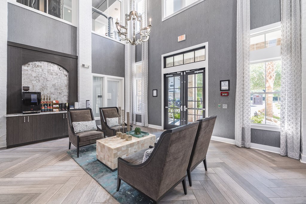 A modern living room with a large couch and a chandelier.