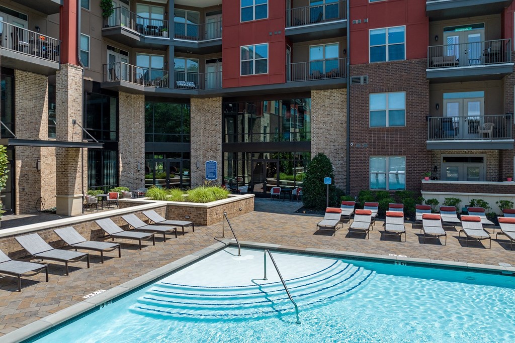 a swimming pool in front of an apartment building