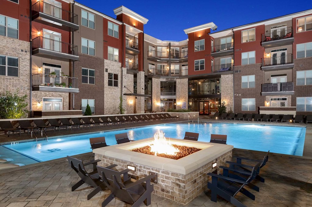 Dog-Friendly Apartments in Duluth, GA - District at Duluth - Boutique Salt Water Pool with Firepit, Adirondack Chairs, Spacious Sundeck, and Lounge Seats.