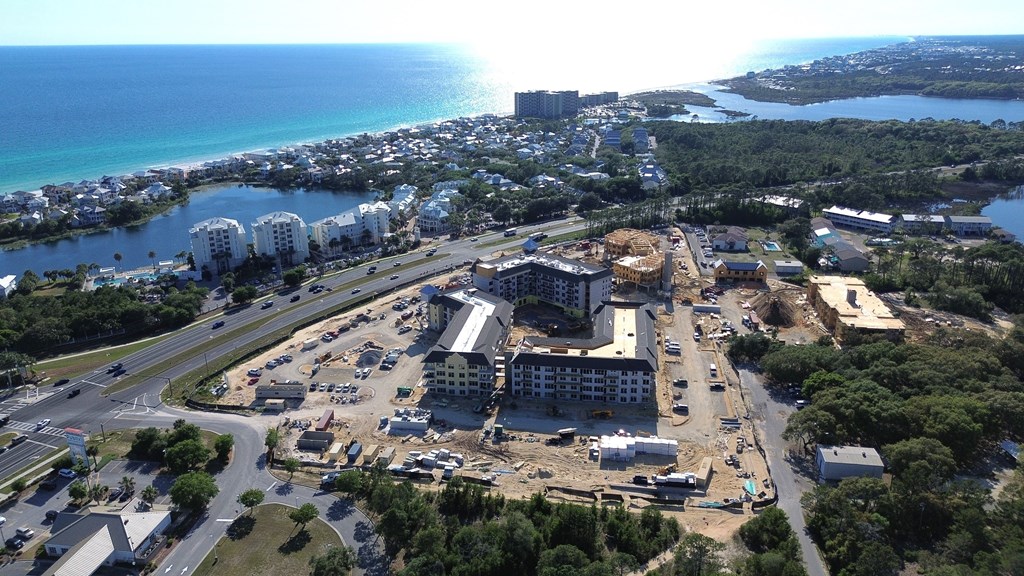 A construction site is seen in the foreground of a coastal city.