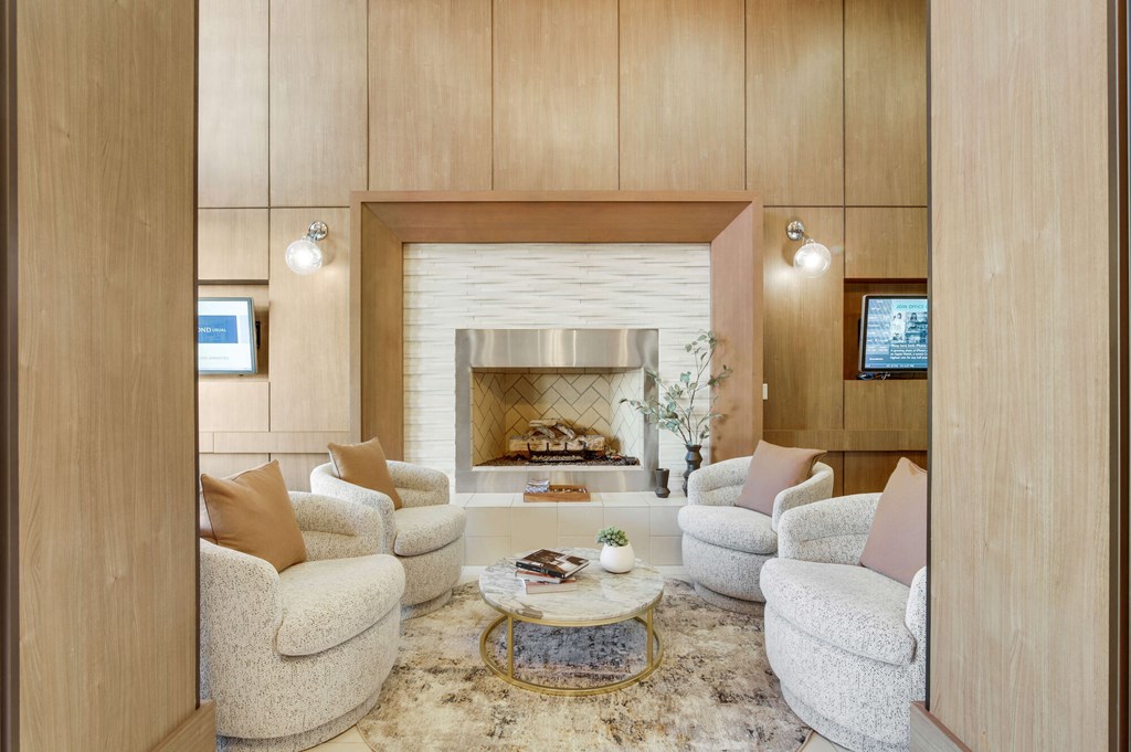 A living room with a fireplace and a TV.