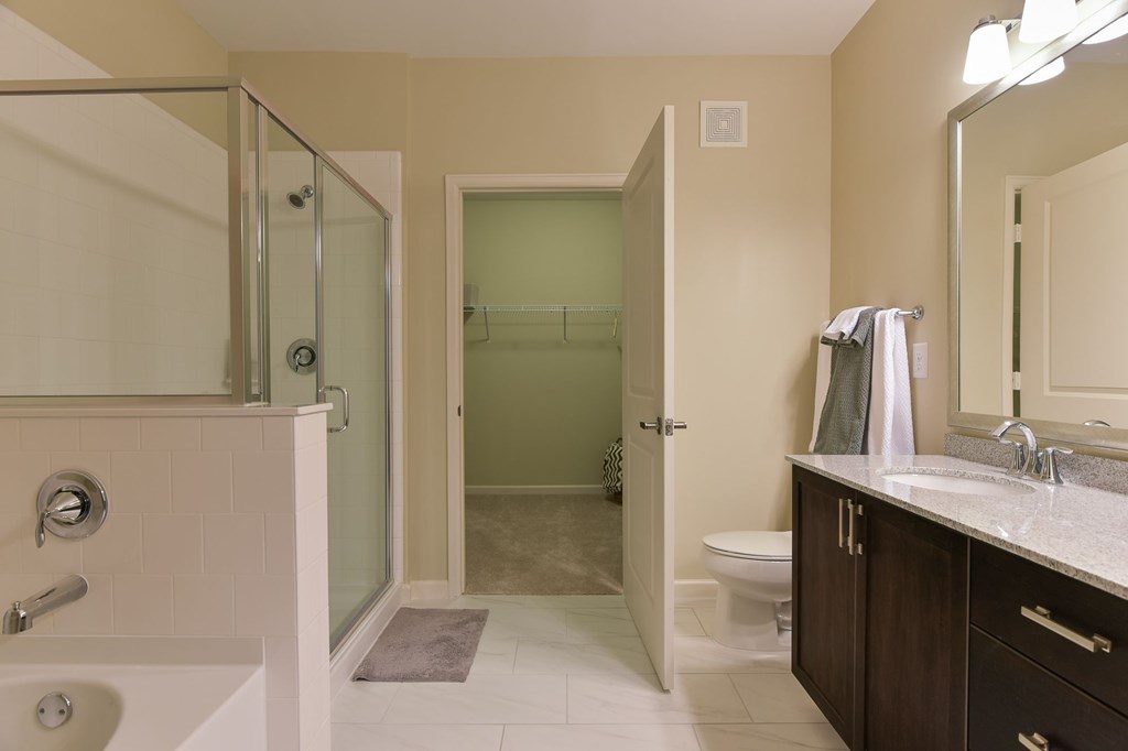 A bathroom with a toilet, sink, and shower.