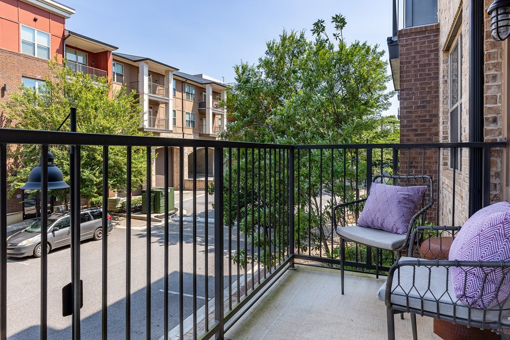 our apartments have a balcony with a chair and a table