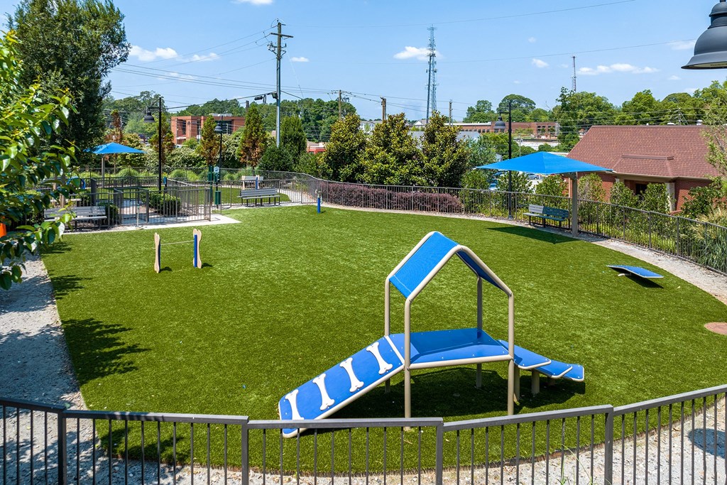a playground with a swing set and a seesaw in a yard