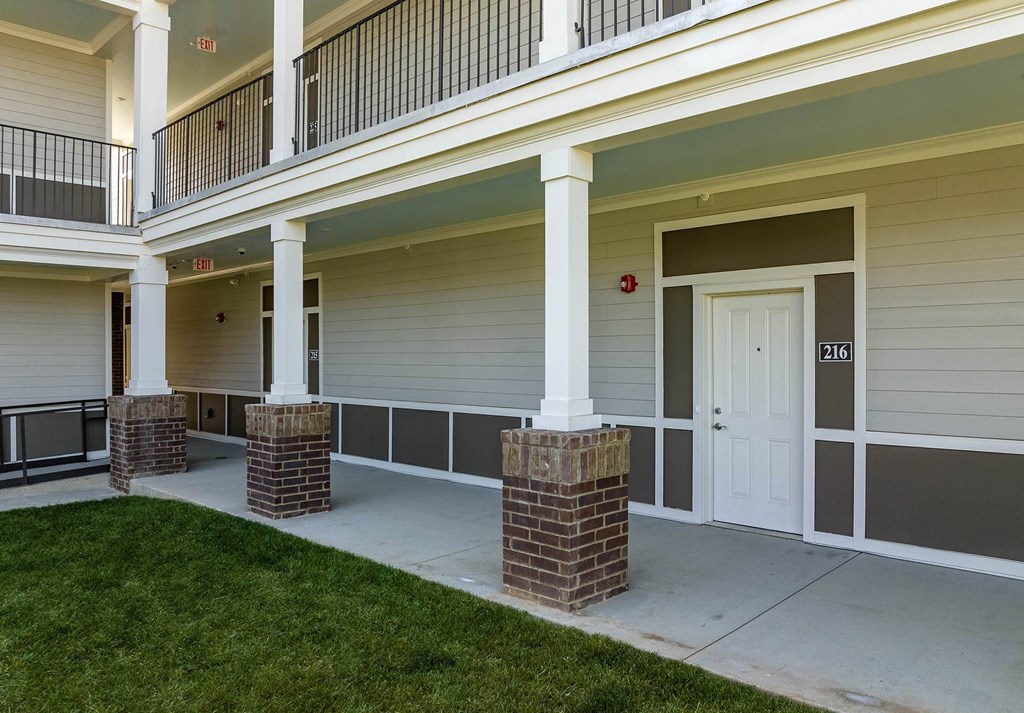 a view of the entrance to a building at the whispering winds apartments in pearland
