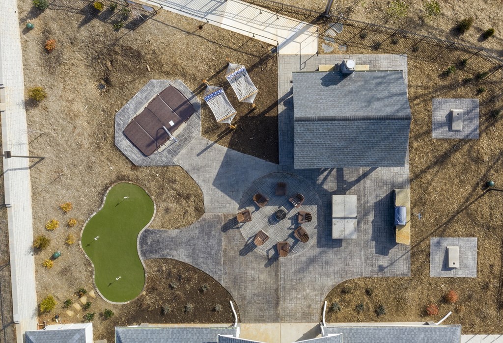 A park with a pond, a pavilion, and a playground.
