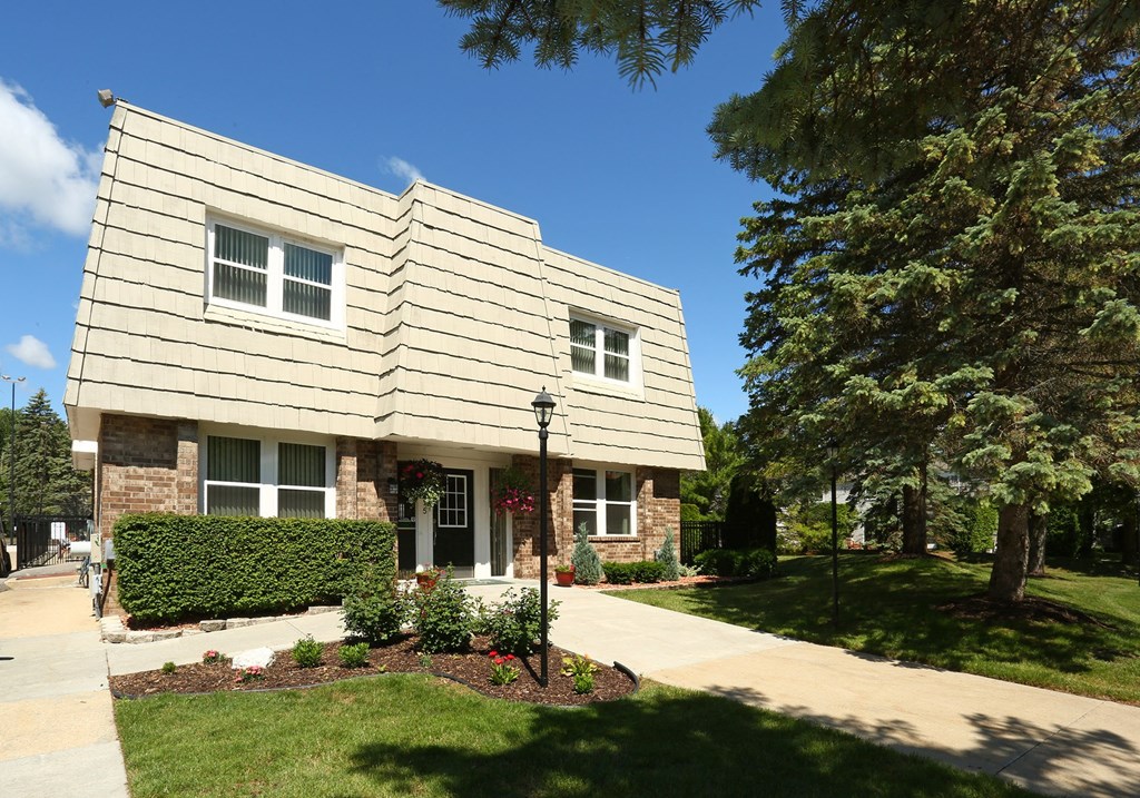 a picture of the front of a building with trees and a sidewalk in front of it  at Pheasant Run, Michigan