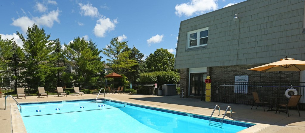 a swimming pool in front of a building  at Pheasant Run, Saginaw, 48638