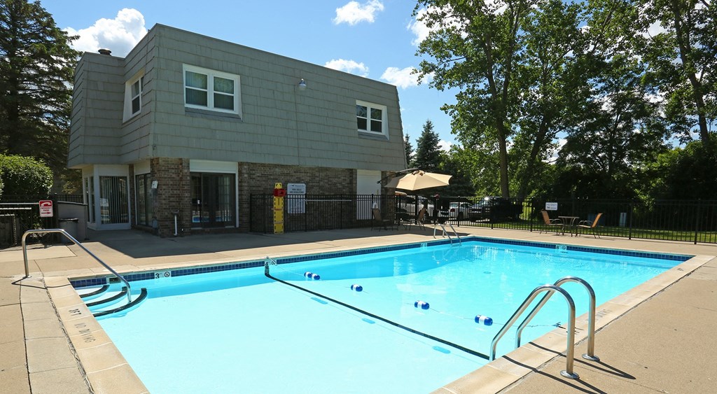 a swimming pool with a gray building in the background  at Pheasant Run, Saginaw, 48638