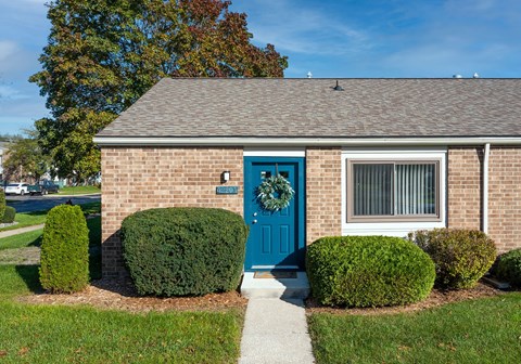 our apartments showcase a beautiful brick building with a blue front door