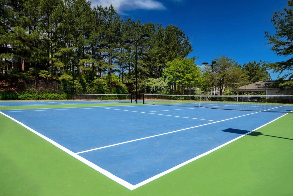 a tennis court with trees in the background  at Thornblade, Greenville, SC, 29615