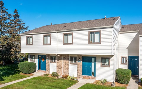 a white house with blue doors and windows