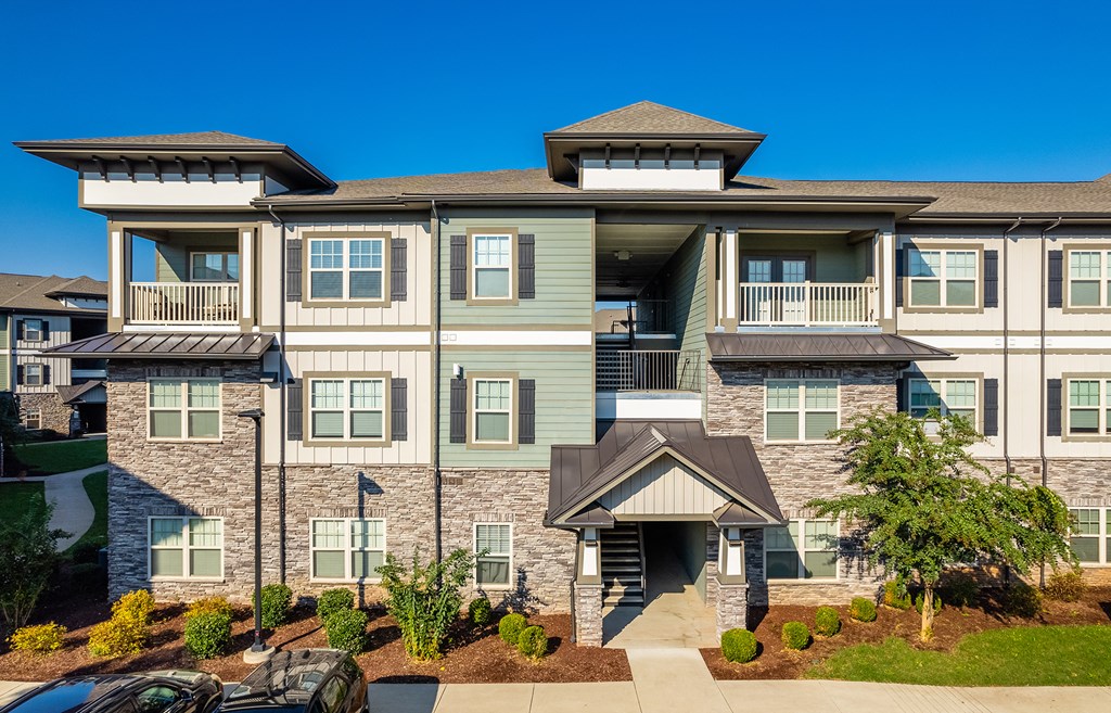 an exterior view of a building with cars parked in front