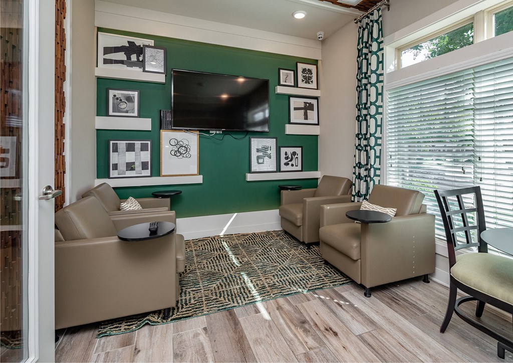 a living room with couches and chairs and a television