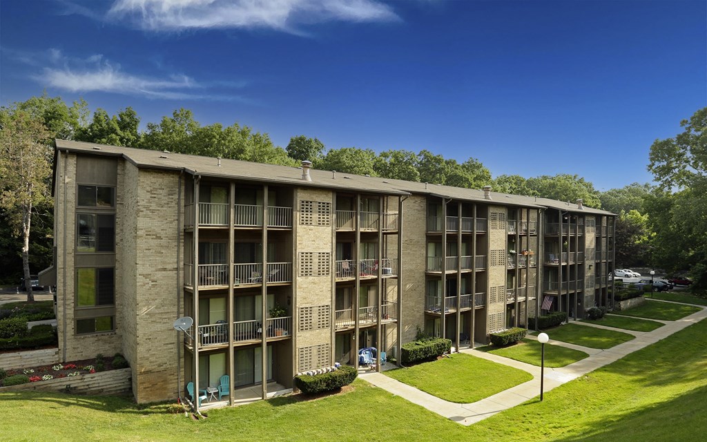 an apartment building with balconies and trees in the background at Winchell Way Apartment , Kalamazoo, 49008