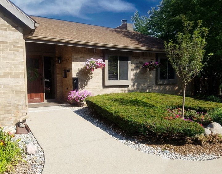 a house with pink flowers on the front of it at Winchell Way Apartment, Kalamazoo, MI, 49008