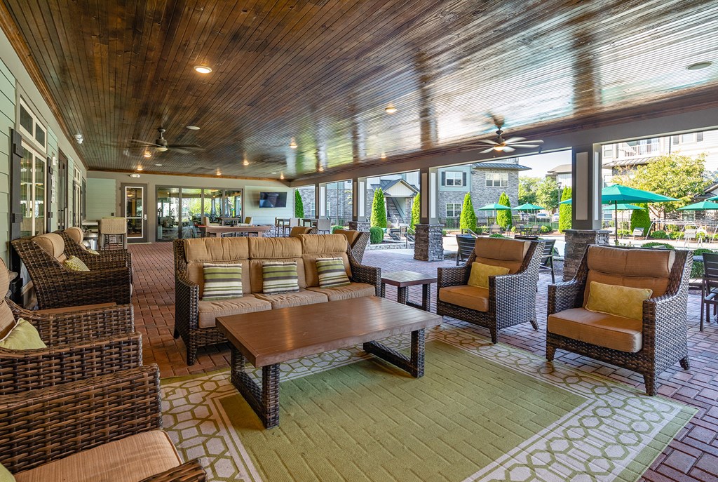 a large patio with couches and chairs and a table