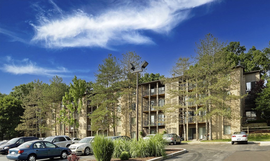 a rendering of an apartment building with cars parked in front of it and trees in the background at Winchell Way Apartment , Michigan, 49008