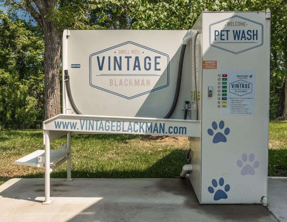 a tent with a sign that says vitrage wash and a bench