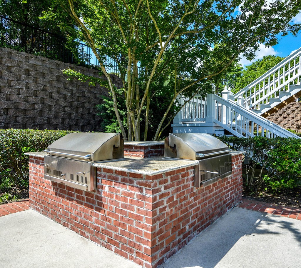 a brick barbecue with two bbq grills and a tree in the background at Crestmont at Thornblade, Greenville, SC, 29615