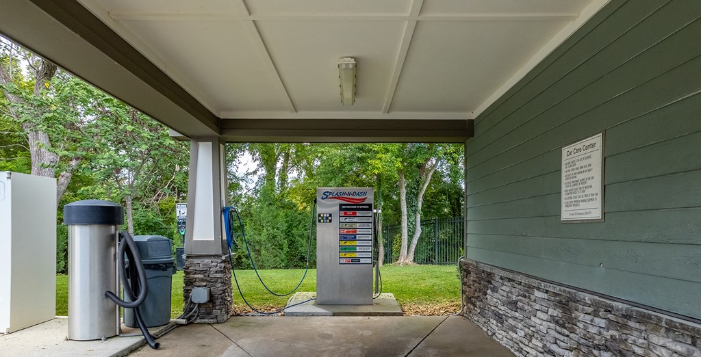 a gas pump in front of a green building