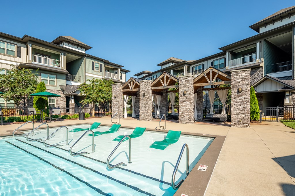 the preserve at ballantyne commons pool with lounge chairs and apartment buildings