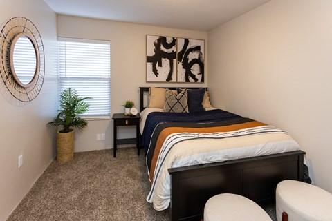 a bedroom with a bed and a potted plant
