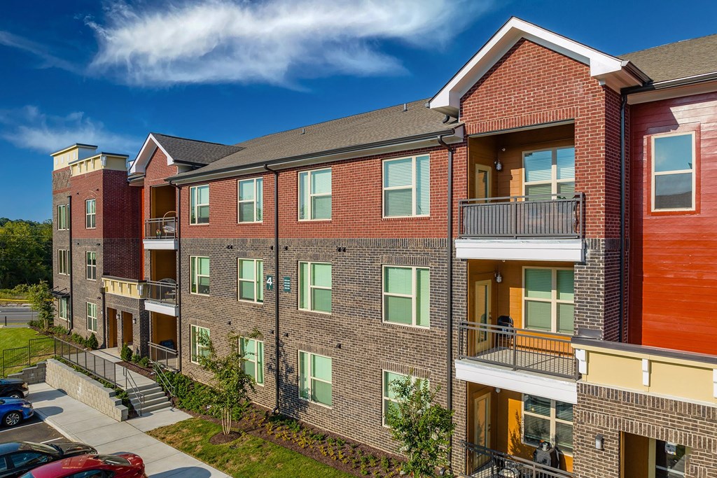an exterior view of a brick apartment building with balconies
