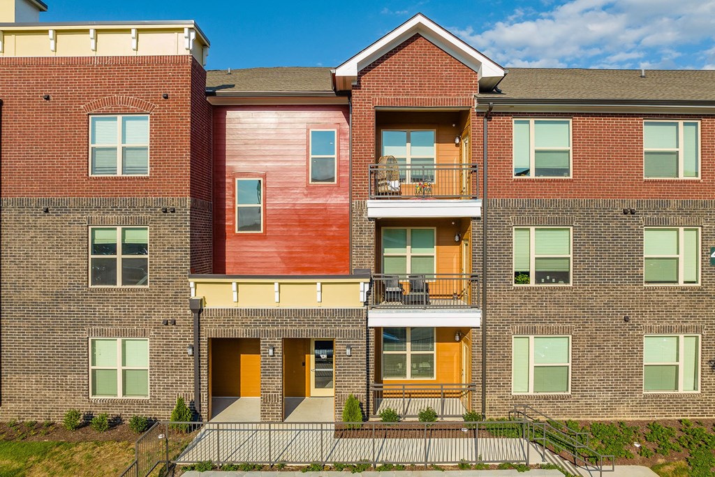 an image of a brick apartment building with balconies