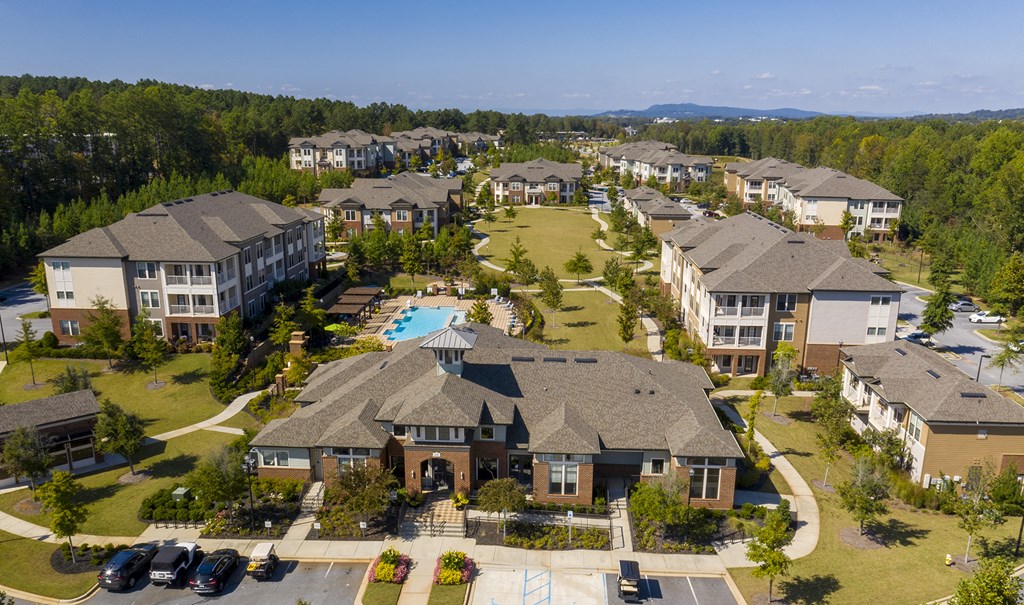an aerial view of a neighborhood with houses and a swimming pool