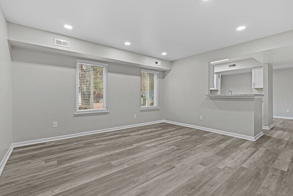 an empty living room with a sink and a window