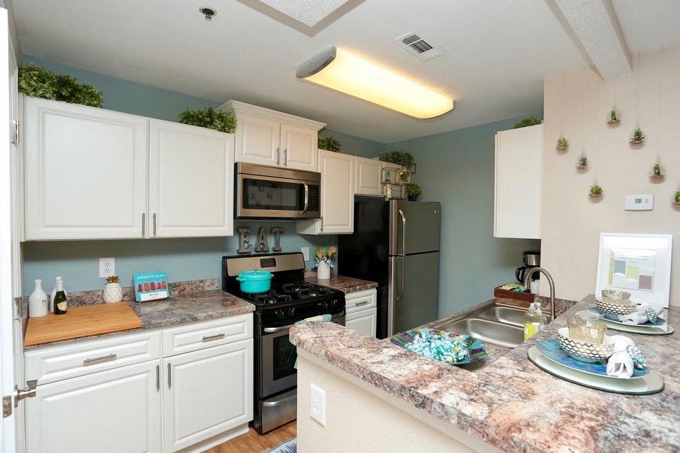 a kitchen with stainless steel appliances and granite counter tops