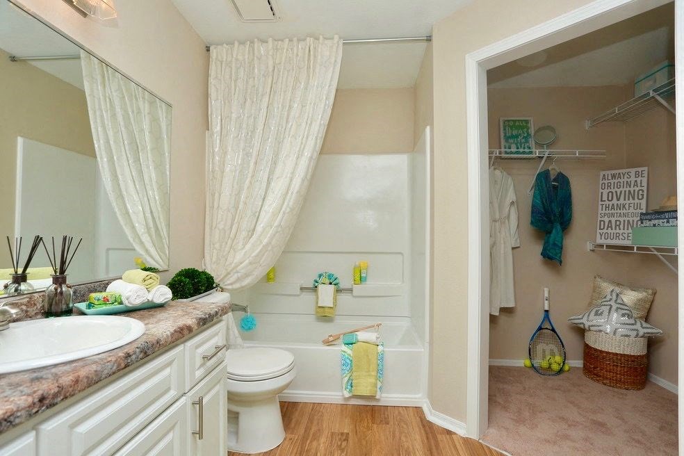 a bathroom with a toilet and a sink and a shower