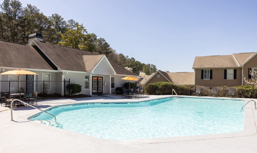 a swimming pool with apartments in the background